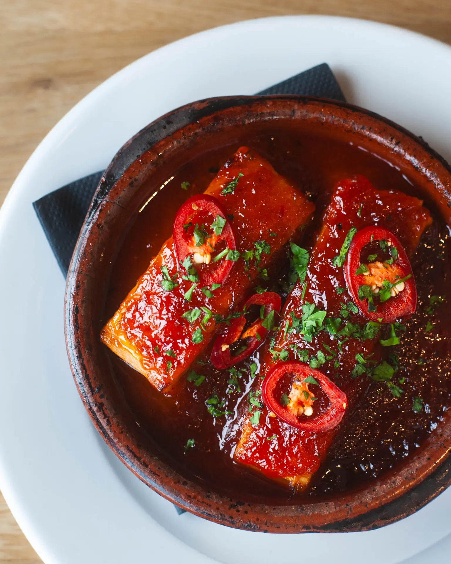 A glazed dish with fresh chilli and herbs