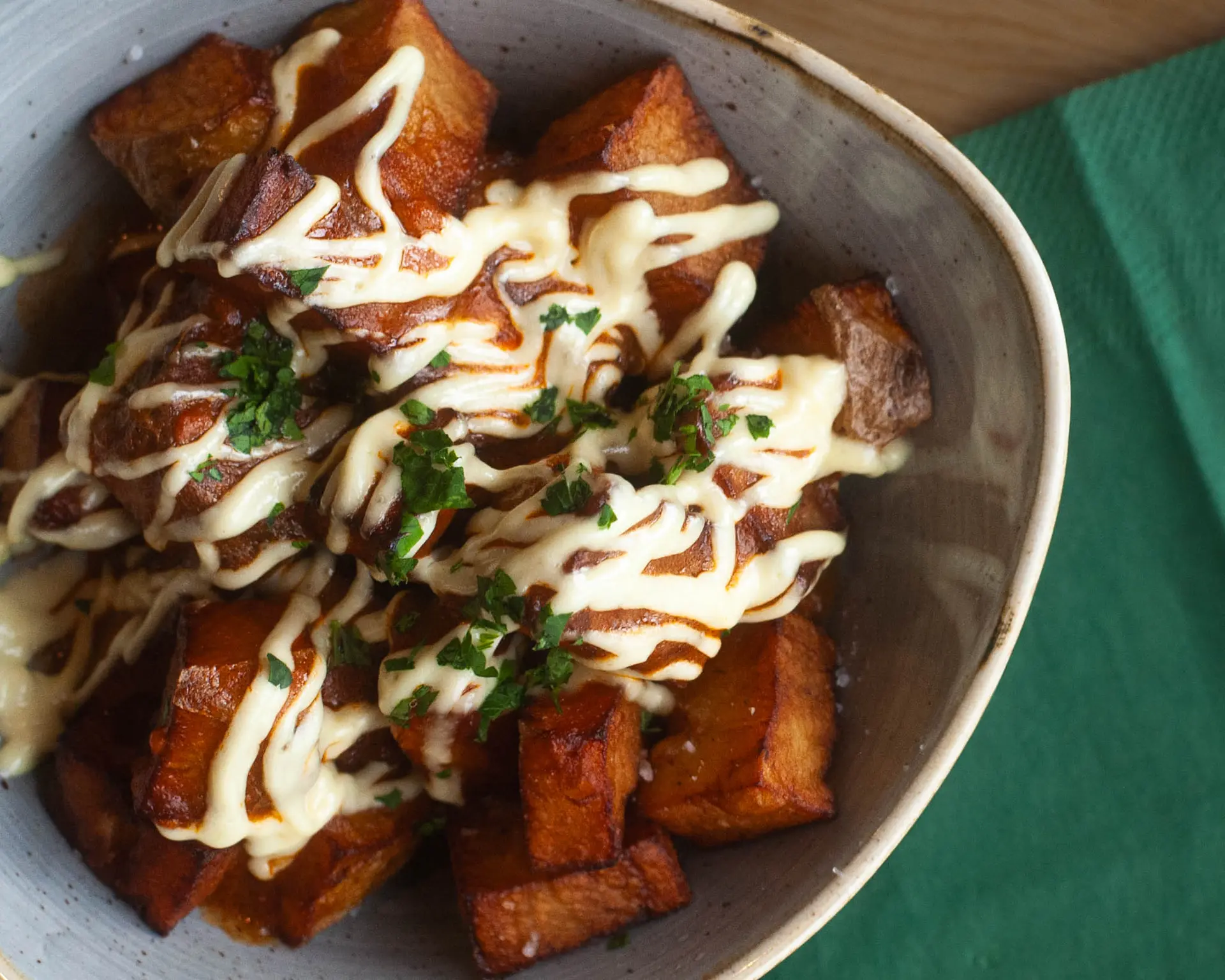 Roasted potatoes with sauce and herbs